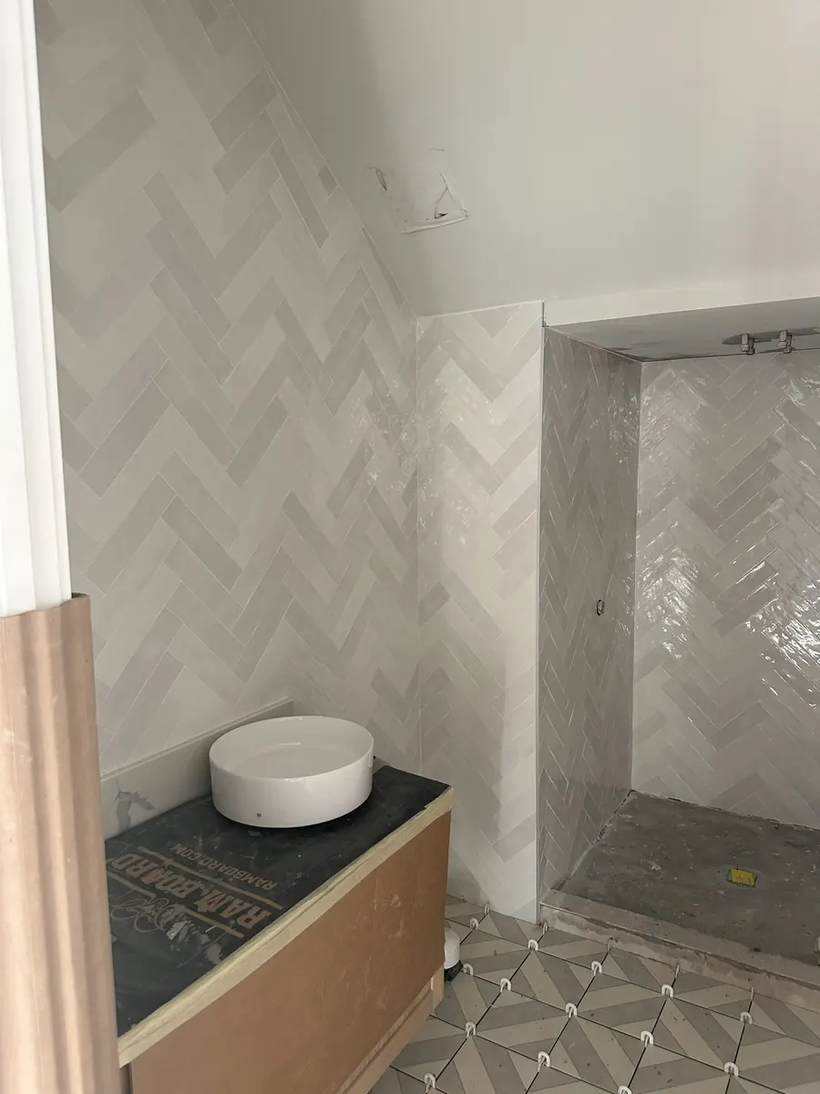 Bathroom tile detail with herringbone wall finish