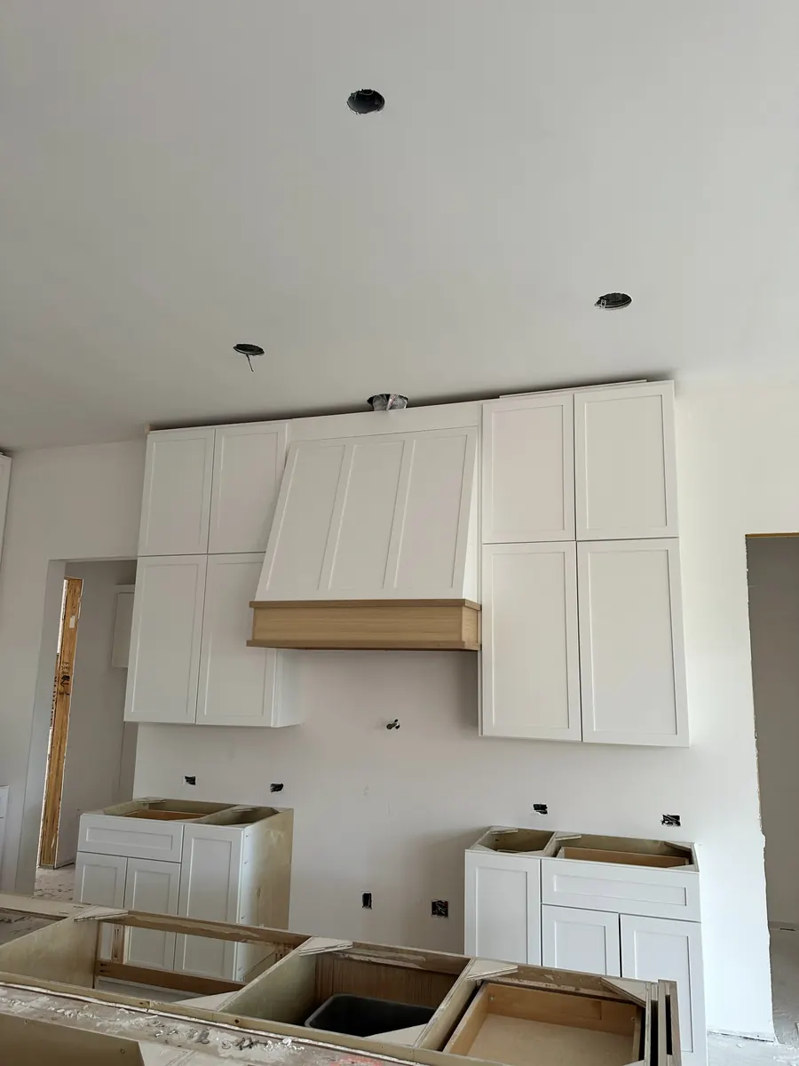 Custom white cabinetry installation in progress