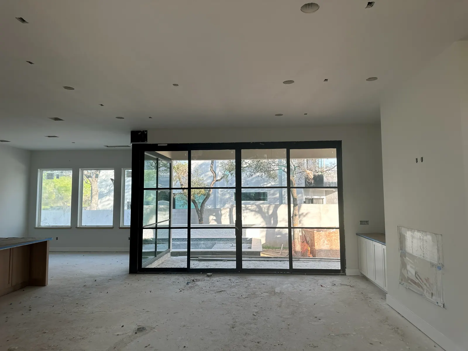 Interior room in progress with new windows and glass doors